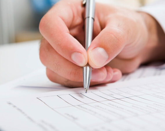 Males hand writing in the document