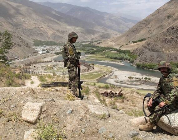 Afghan National Army soldiers keep watch along a road during a security handover ceremony in Panjshir province